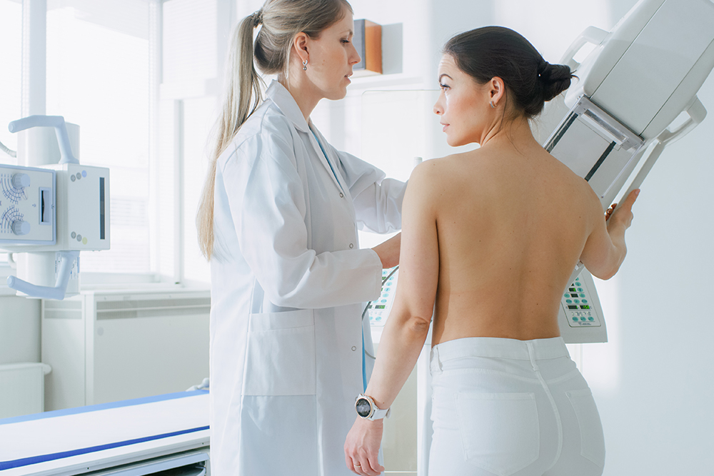 Radiologist giving a woman a mammogram depicting cancer screening to go along with Florida Cancer Stats by Florida Cancer Support Network.