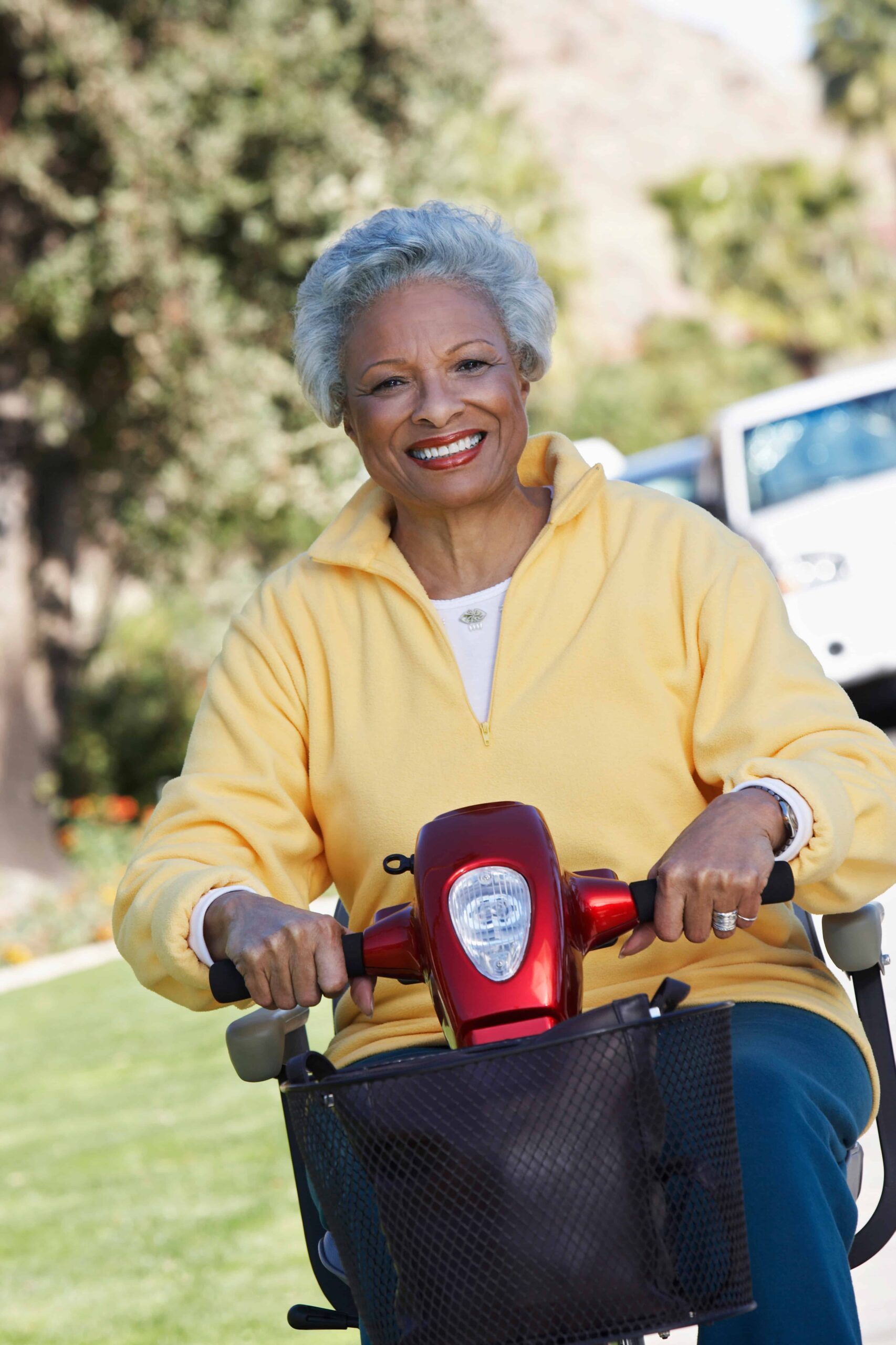 Portrait of an African American senior woman on motor scooter