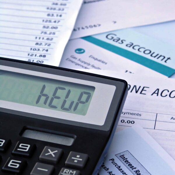 AdobeStock_4401384 Bills & Calculator displaying "HELP"