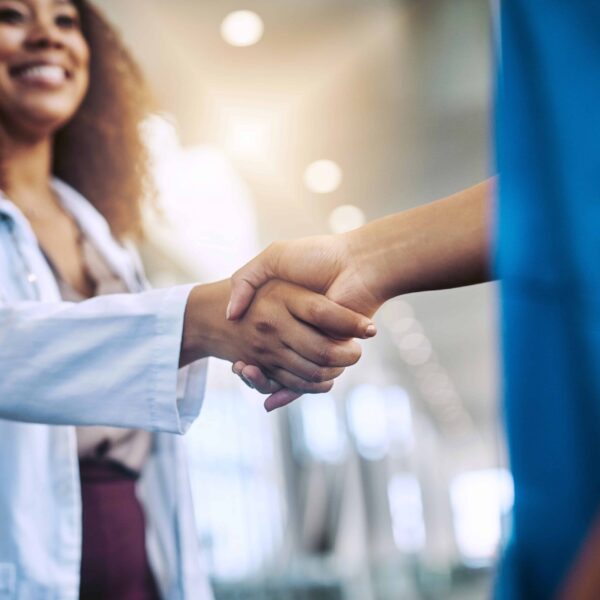 Woman, handshake and medical in hospital for partnership
